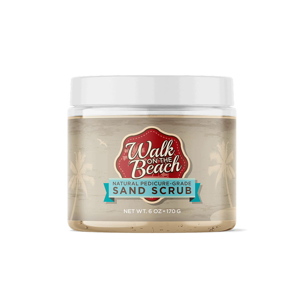 A clear plastic jar with a white lid, labeled Perfectly Posh Walk on the Beach Foot Scrub, features palm trees and beach graphics. The 6 oz (170 g) jar contains a natural pedicure-grade exfoliant scrub.