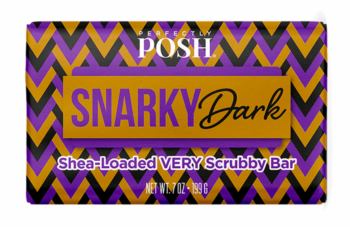 A rectangular package with a zigzag purple, black, and gold design labeled Perfectly Posh SPOOKY SNARKY CHUNK bar, Net Wt. 7 oz (199 g).